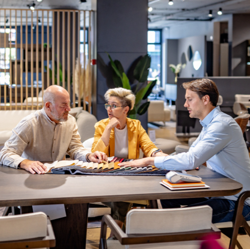Business partners discussing fabric samples on table in modern office setting