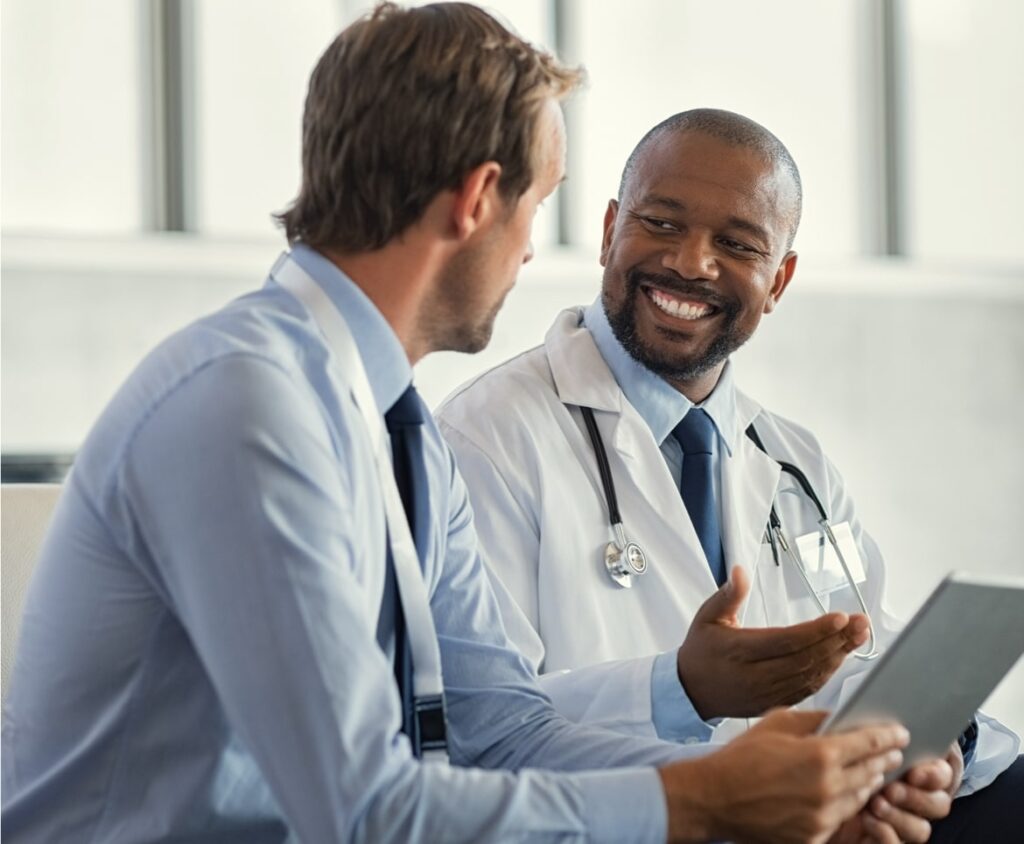 Doctor discussing results with patient, showcasing TrualignHealthcare partners' approach of healthcare professionals listening attentively