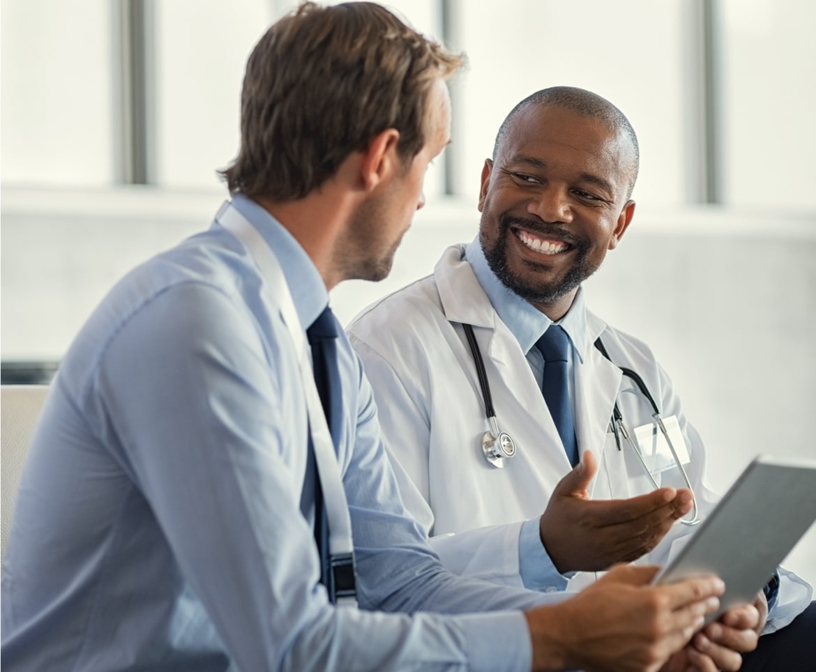 Doctor discussing results with patient, showcasing TrualignHealthcare partners' approach of healthcare professionals listening attentively